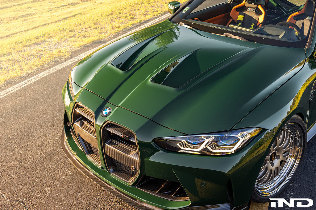 Alpha N G8X M3 M4 carbon vented hood exterior car part with aerodynamic design and vent openings.