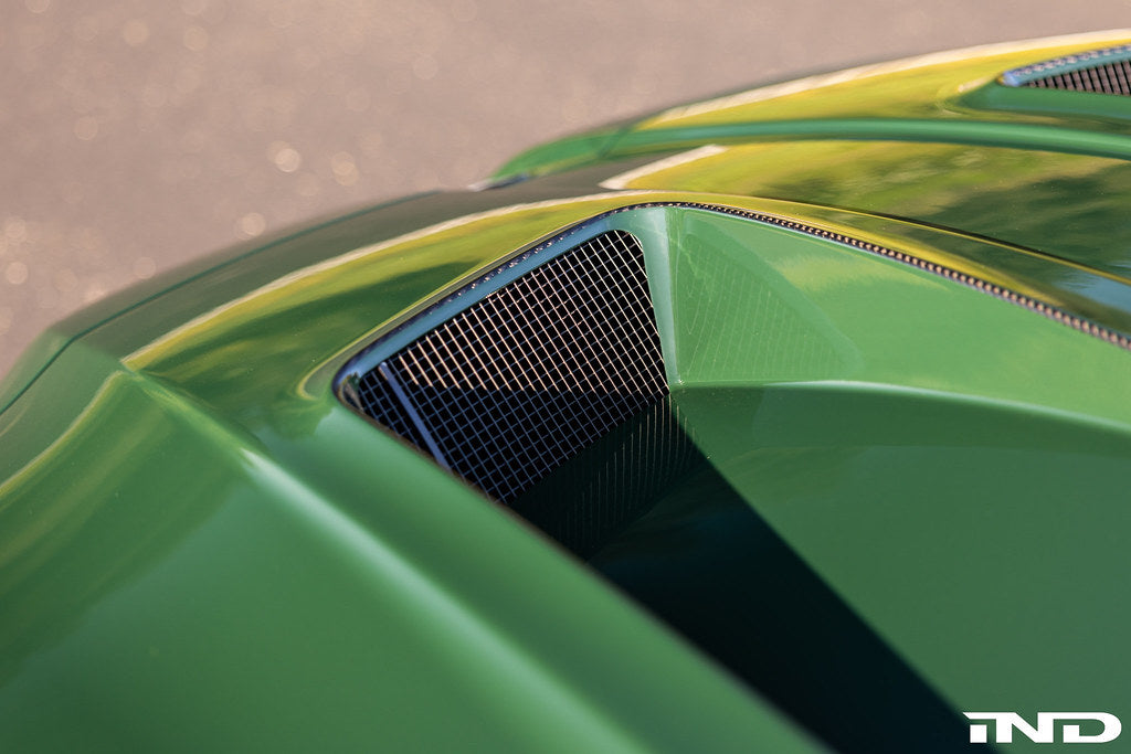 Alpha N Alpha-N G8X M3 M4 carbon vented hood installed on a vehicle, showcasing the sleek exterior design and lightweight construction.