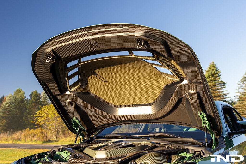 Alpha-N G87 M2 Carbon Vented Hood installed on a BMW M2 Clubsport, showcasing lightweight carbon fiber and vented design.