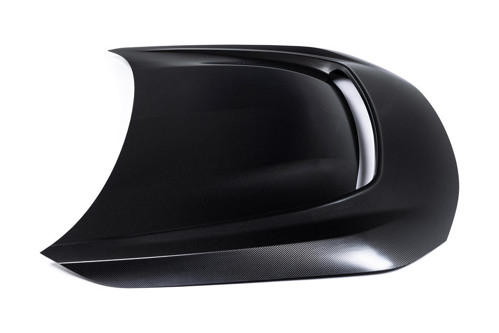Alpha-N G87 M2 carbon vented hood on a white background, showcasing its sleek exterior design and lightweight construction.