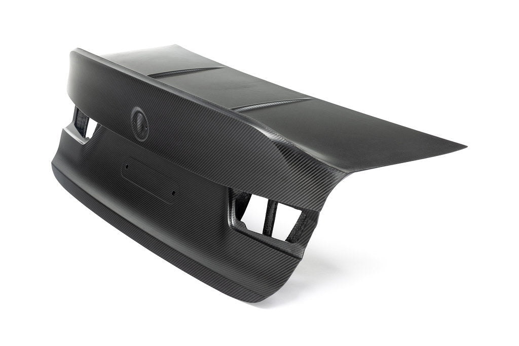 Alpha N G80 M3 Carbon CSL trunk lid installed on a white background, showcasing its lightweight carbon fiber exterior design.