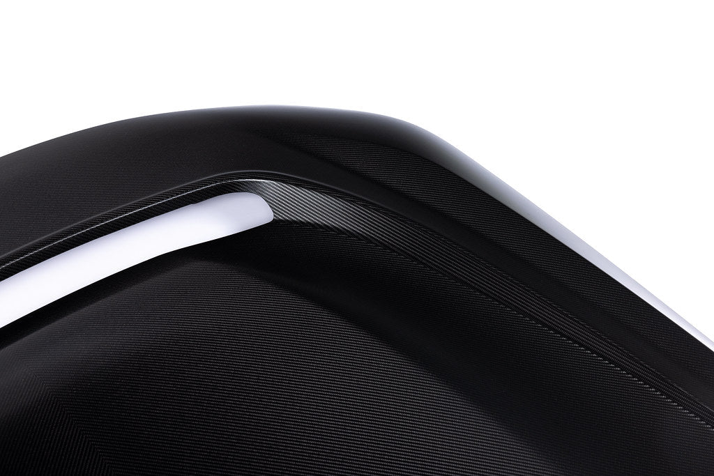 Alpha N G87 M2 carbon vented hood installed on a car, showcasing lightweight, aerodynamic exterior design against a white background.