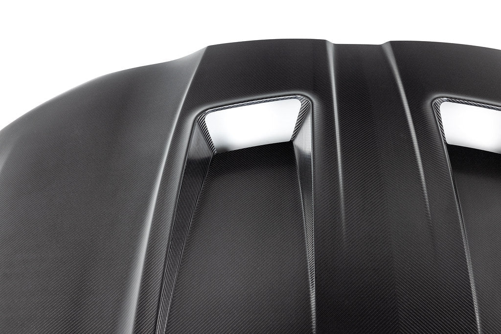 Alpha-N G8X M3 M4 carbon fiber vented hood in raw finish, exterior car part with a lightweight, vented design.